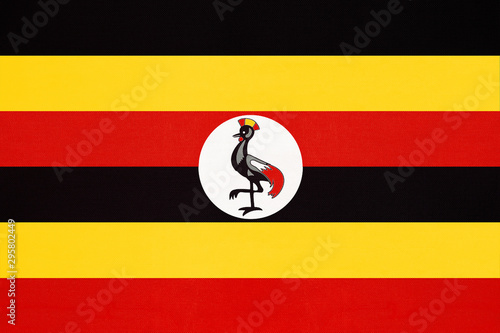 Republic of Uganda national fabric flag, textile background.