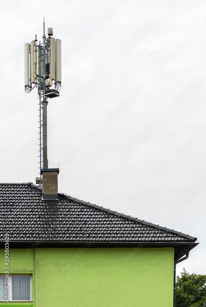 5G antennas on top of house. Antennas and transmitters on roof. 5G antennas on top of house. Antennas and transmitters on roof.