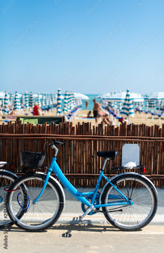 Rental bikes on the beach. Blue bicycles on the street.