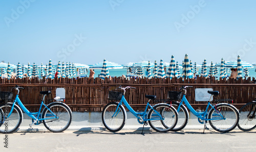 Rental bikes on the beach. Blue bicycles on the street. photo