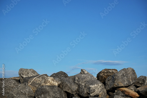 The stone wall with blue sky background. © Missleestocker