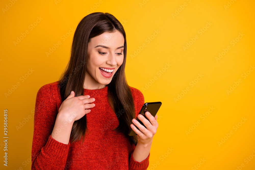 Naklejka premium Photo of beautiful charming nice attractive girlfriend rejoicing with feednews information on telephone she holds isolated over yellow vivid color background