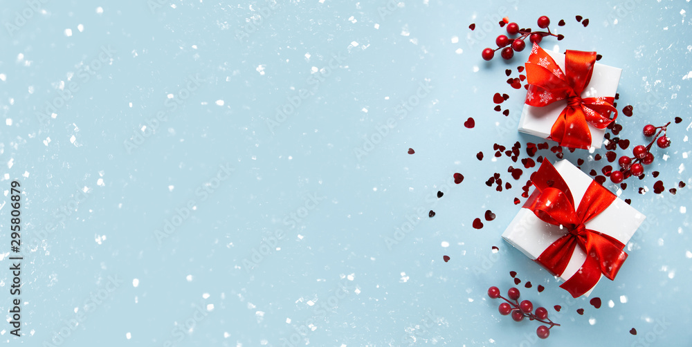 Christmas and New Year holiday background. Xmas greeting card. Christmas gifts on blue background top view. Flat lay Christmas and New Year holiday background. Xmas greeting card. Christmas gifts on blue background top view. Flat lay
