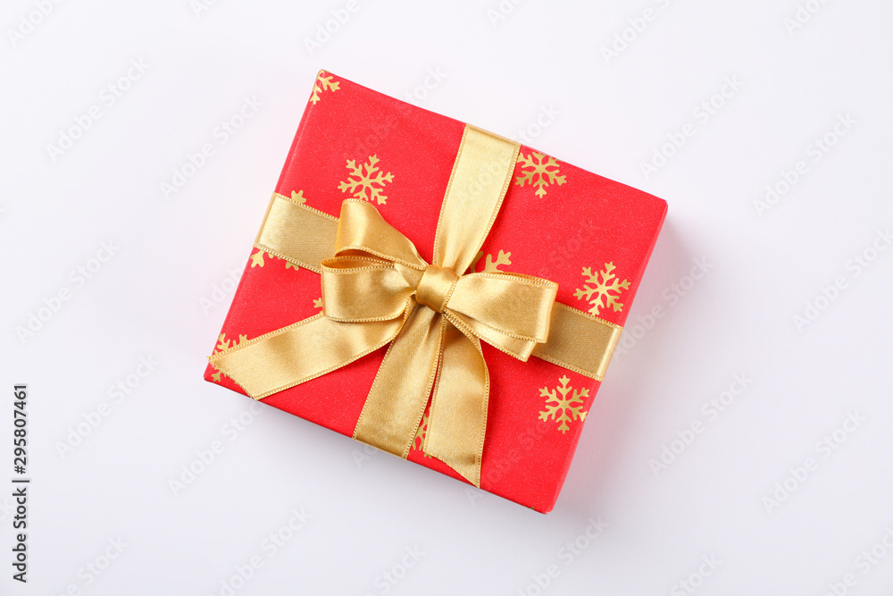 Beautiful gift box with golden bow on white background, space for text Beautiful gift box with golden bow on white background, space for text
