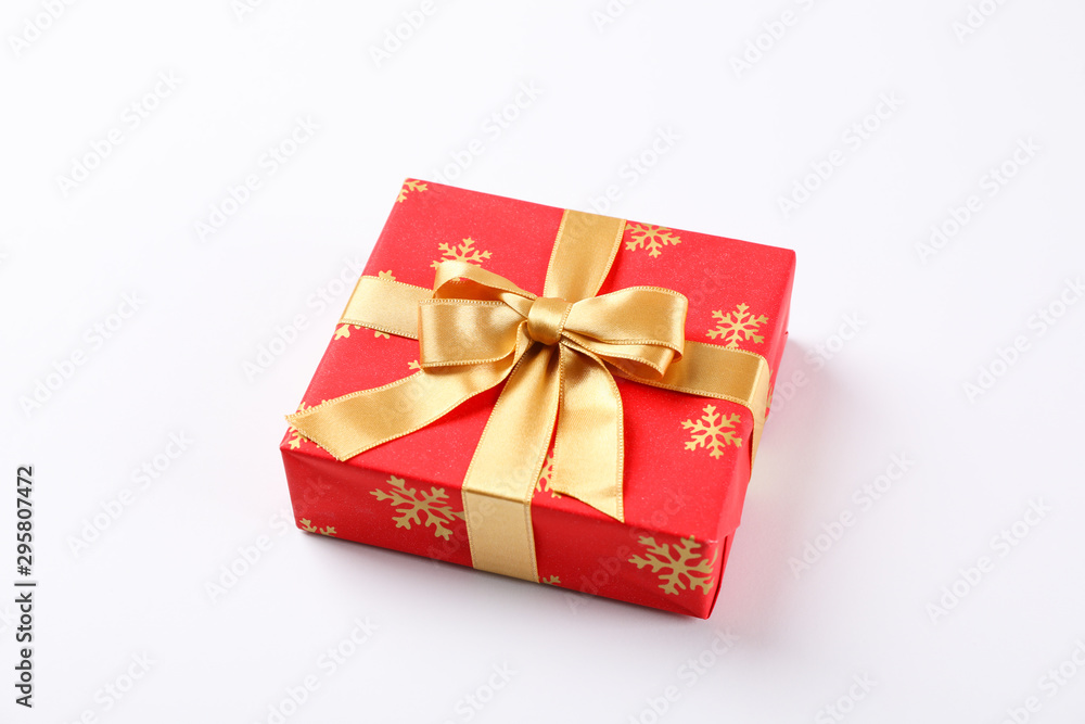 Obraz premium Beautiful gift box with golden bow on white background, space for text