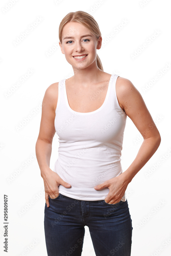 Happy relaxed smiling young woman in jeans and t-shirt standing isolated on white Happy relaxed smiling young woman in jeans and t-shirt standing isolated on white