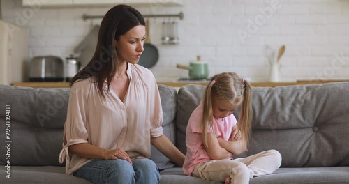 Angry young mother scolding shouting at stubborn fussy kid daughter