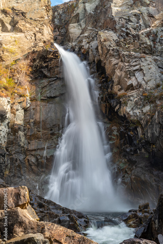 mountain river and waterfall on a background of autumn trees