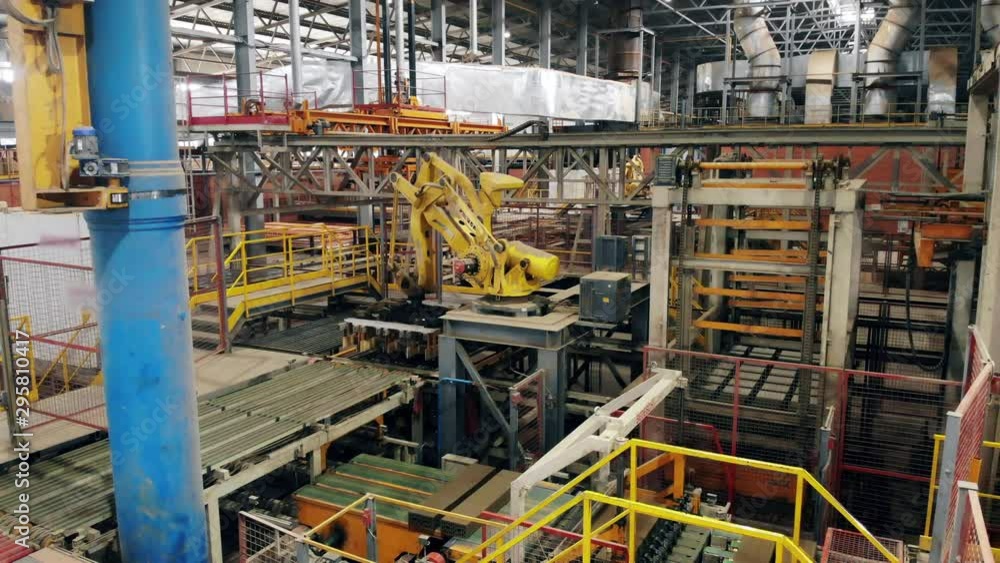 Factory equipment with a robotic arm moving around Factory equipment with a robotic arm moving around