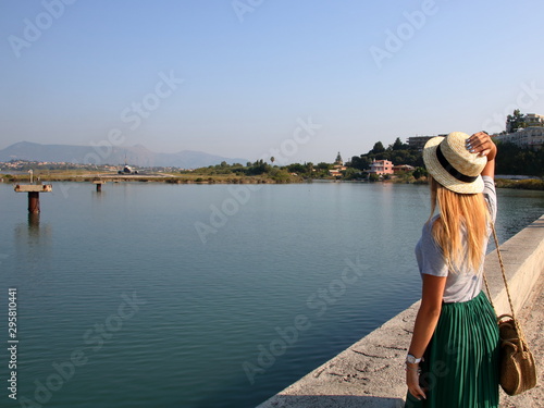 woman watching a plane close to kerkyra airport, corfy, greece