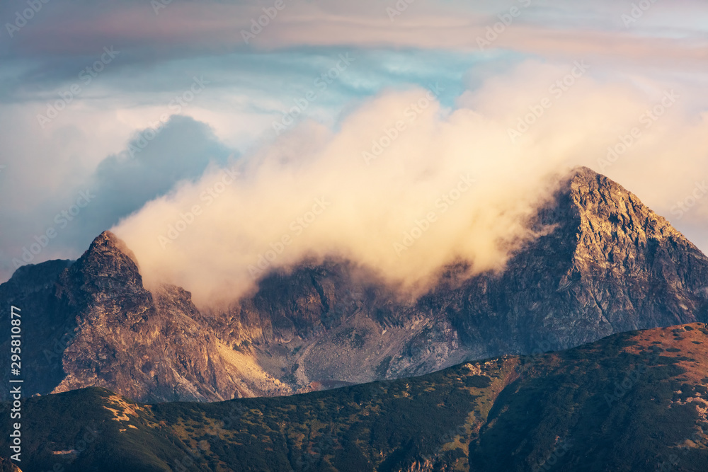 Mountain peaks in clouds at sunset. Tatra Mountains, Poland
