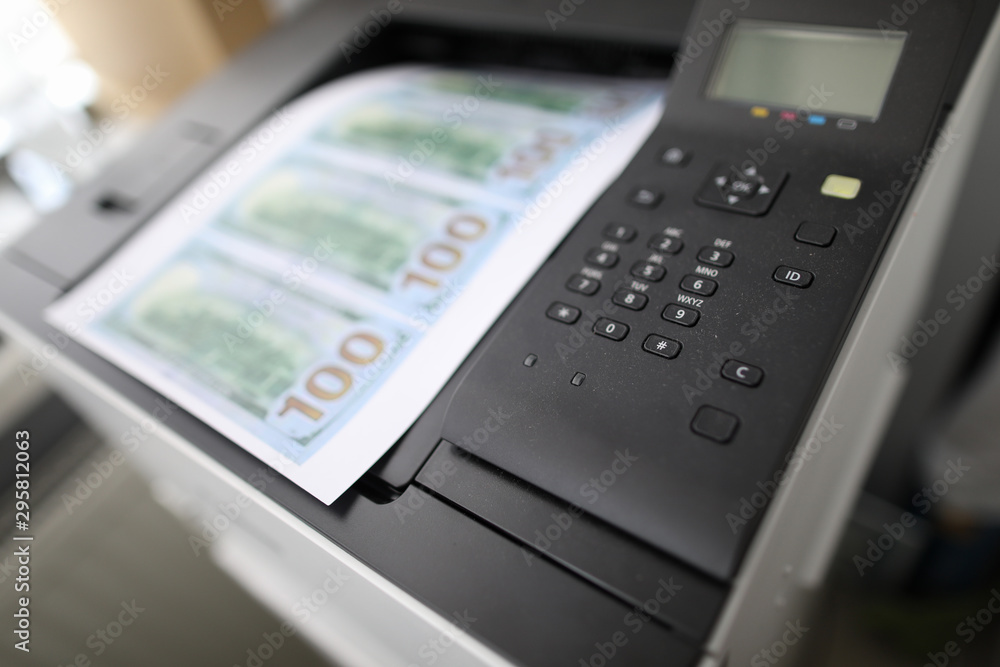 Sheet of paper printed on a printer with fake dollars Sheet of paper printed on a printer with fake dollars