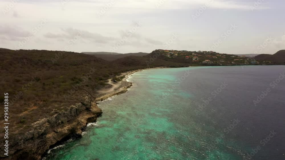 Aerial view of coast of Curaçao in the Caribbean Sea with turquoise water, cliff, beach and beautiful coral reef around Playa Largu Aerial view of coast of Curaçao in the Caribbean Sea with turquoise water, cliff, beach and beautiful coral reef around Playa Largu