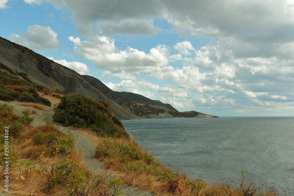 landscape view of coastline, cloudy sky and sea