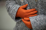 Girl in orange classic gloves and a goose foot coat
