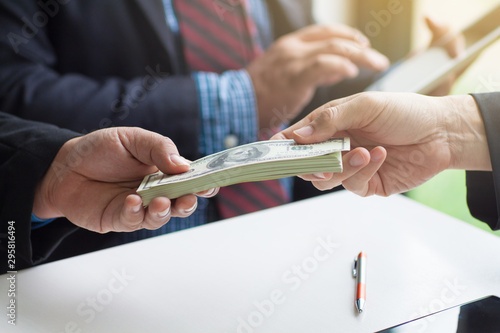 Businessmen give money to businessmen. Business people get money from business people. Businessmen pay the deposit after the contract has been completed. photo