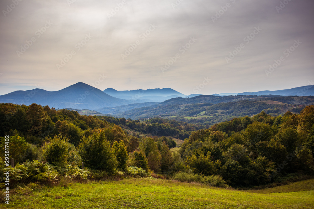 Obraz premium First autumn colors in early fall on mountain at cloudy day. Mountain near the Banja Luka in Bosnia and Herzegovina.