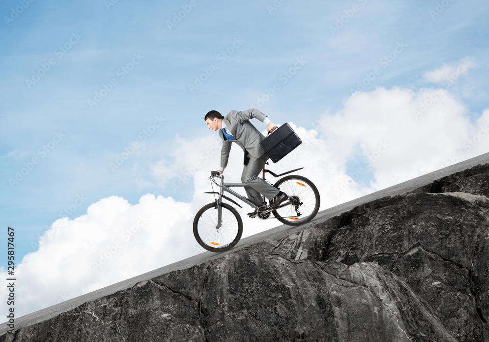 Naklejka premium Young man riding bicycle on highway