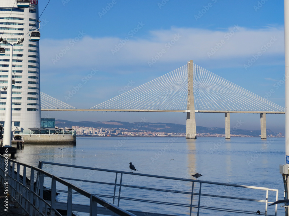 Fototapeta premium Vasco da Gama bridge in the Parque das Nacoes (Park of Nations) in Lisbon is a Modern Cultural Center And A Place For A Shopping Mall,