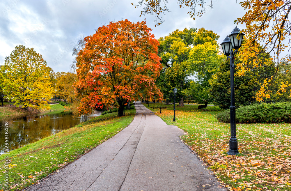 Autumn in central public park of Riga - capital and largest city of Latvia, a major commercial, cultural, historical and tourist center of the Baltic region 