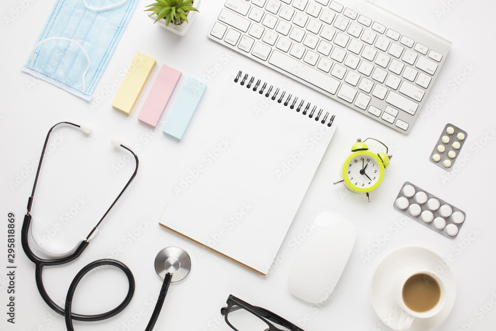 Medical equipment and office supplies with coffee cup over doctor desk Medical equipment and office supplies with coffee cup over doctor desk