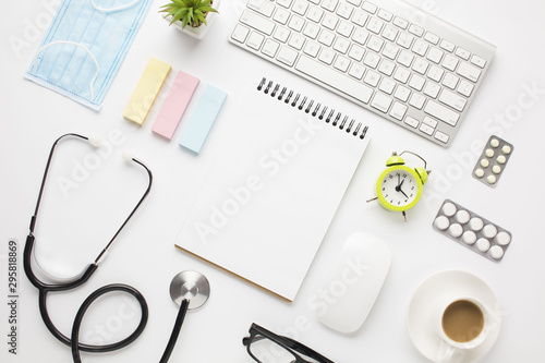 Medical equipment and office supplies with coffee cup over doctor desk