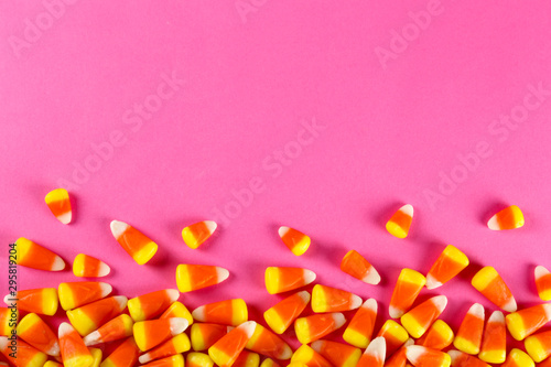 Fotografie Bunch of candy corn sweets as sybol of Halloween hoiday on textured background with a lot of copy space for text