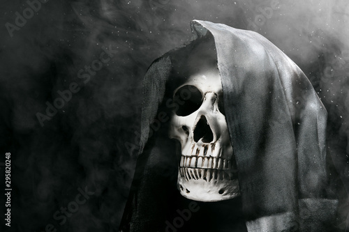 Human skull with a black cloak