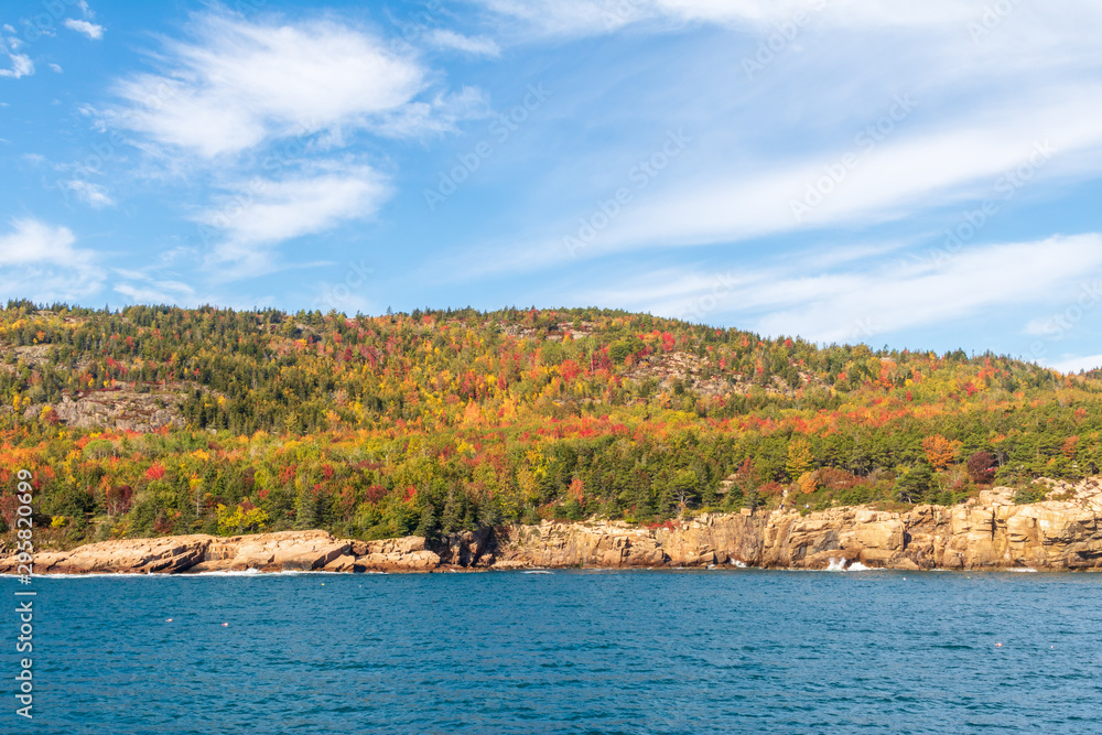 Autumn leaves provide color to the hills on the coast of Acadia National Park