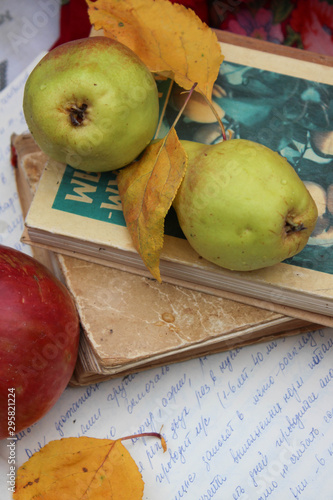 green pears and old book on a light background