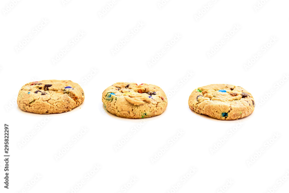 Cookies with colored chocolate dragees on a white background.
