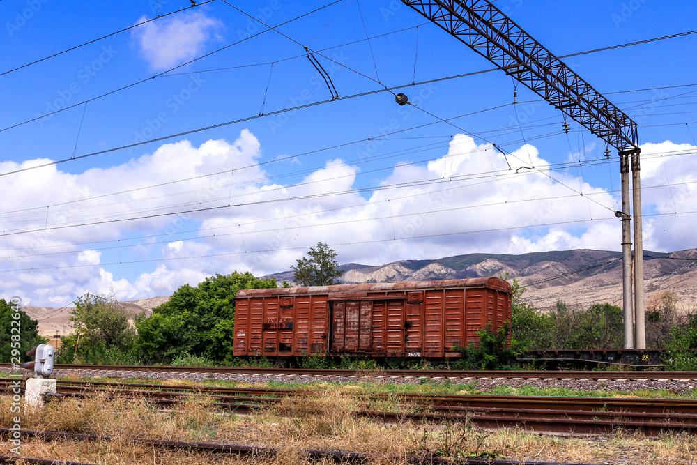 Railway road and old freight cars on background.