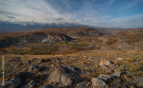 Winding river on a background of mountains and autumn trees