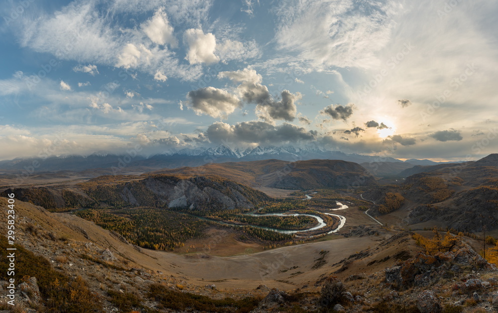 Winding river on a background of mountains and autumn trees