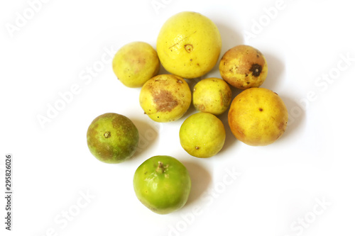 fresh and green lemon with tainted lemon on a white background