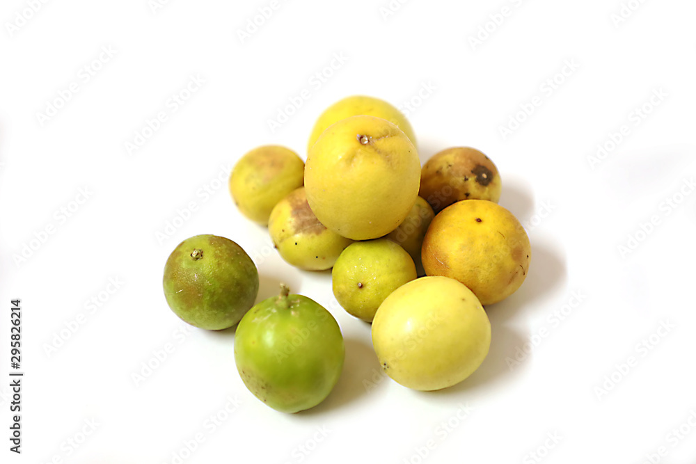 fresh and green lemon with tainted lemon on a white background fresh and green lemon with tainted lemon on a white background