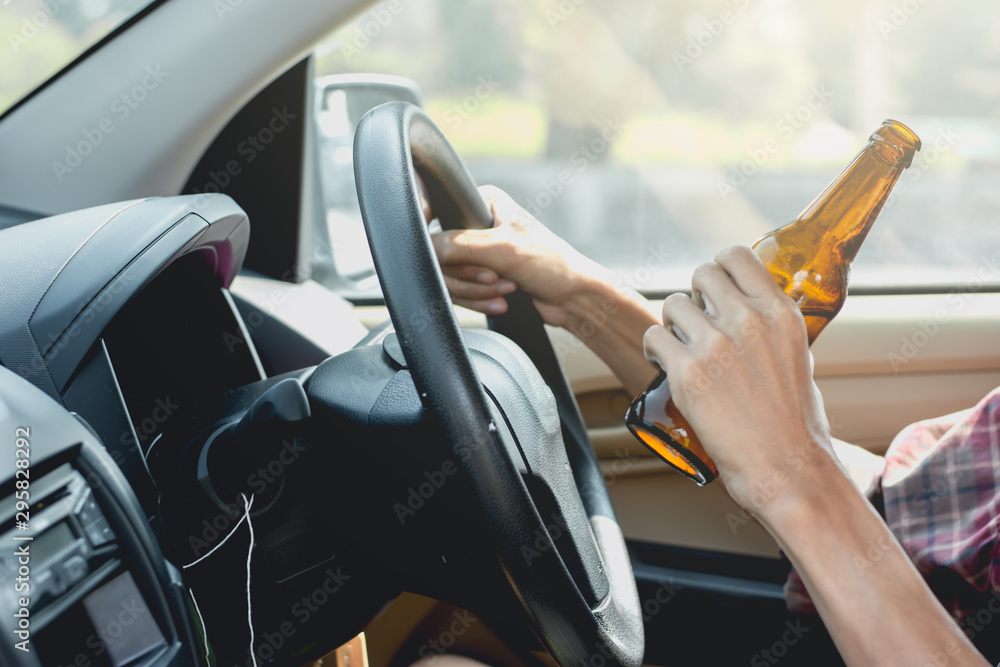 Naklejka premium Young tourists are driving while drinking alcohol.