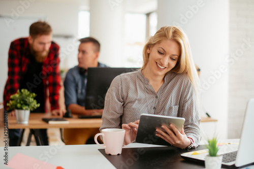 Young businesswoman using tablet in the office