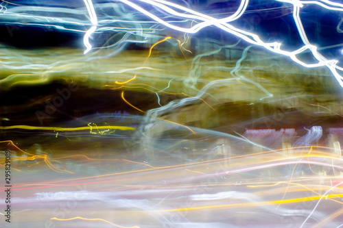 Abstraction of the night city. Glowing chaotic stripes on a black background.