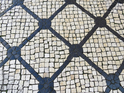 Background texture of the Typical portuguese walkway pavement with old stone in the streets of Lisbon, Portugal