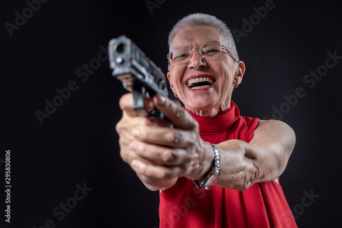 Old lady aiming with her weapon while smiling