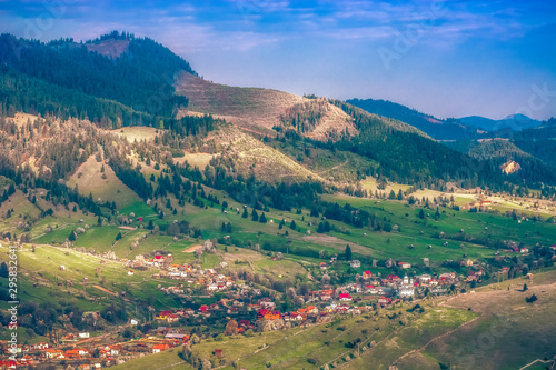 Beautiful landscape mountain hill meadow sunrise morning village Bucovina Romania 