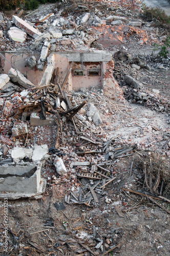 The ruins of the house. Bricks, plaster, boards, iron