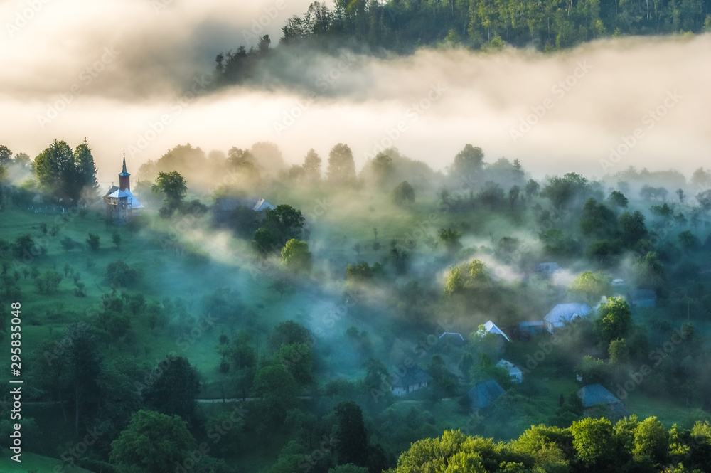 Beautiful scenery landscape sunrise foggy morning village Maramures Romania 