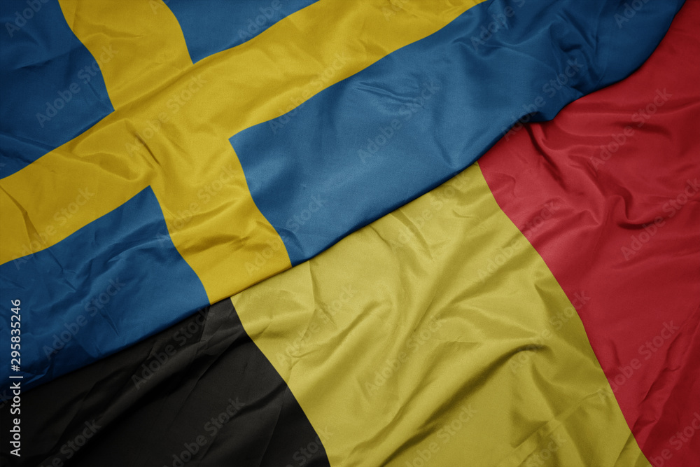 waving colorful flag of belgium and national flag of sweden.