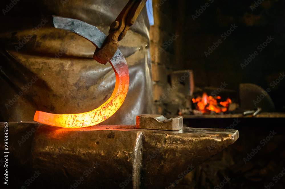The Blacksmith horse shoe maker fire anvil indoor activity traditional