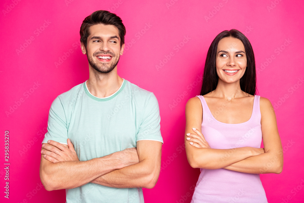 Photo of amazing couple guy and lady looking side childish mood crossing arms wear casual clothes isolated vibrant pink color background Photo of amazing couple guy and lady looking side childish mood crossing arms wear casual clothes isolated vibrant pink color background