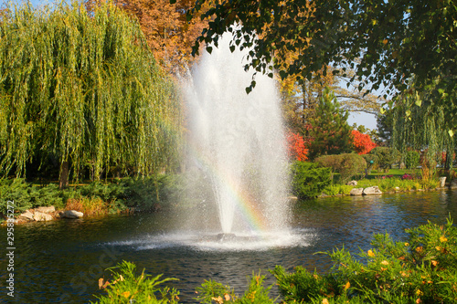 Beautiful autumn park with colorful trees  lake and fountain. Autumn in park  panorama