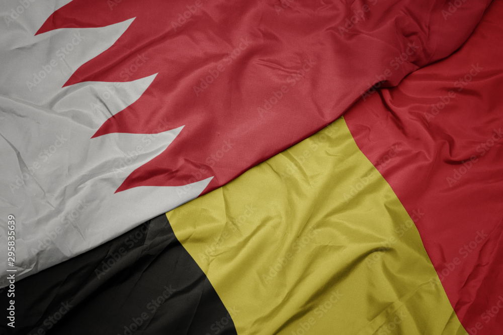 waving colorful flag of belgium and national flag of bahrain.