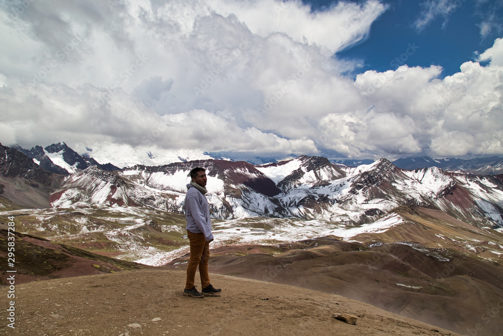 Man with panoramic view. Hiking scene in Vinicunca, Cusco region, Peru. Montana of Seven Colors, Rainbow Mountain Man with panoramic view. Hiking scene in Vinicunca, Cusco region, Peru. Montana of Seven Colors, Rainbow Mountain